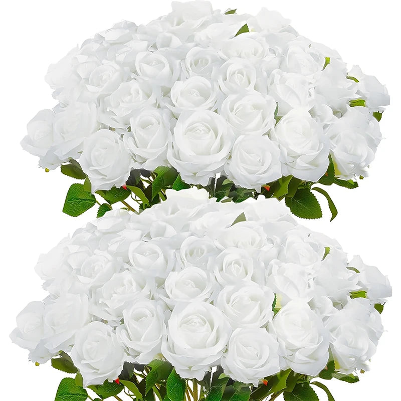 A bouquet of white artificial roses with green leaves.
