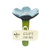 A light blue flower with a yellow center mounted on a green stick, labeled Gups for Bee.