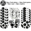 A set of cow print number foil balloons, plates, cups, and napkins for a farm-themed party.