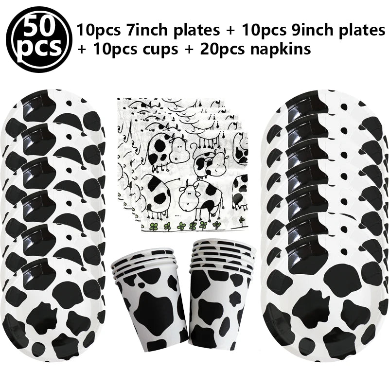 A set of cow print number foil balloons, plates, cups, and napkins for a farm-themed party.