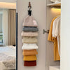 A multilayer hat organizer rack with various colored knitted hats hanging on a closet door.