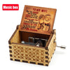 A carved wooden music box with an open lid featuring a vintage-style illustration of a couple.
