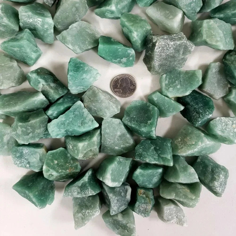 A collection of raw green aventurine crystal stones arranged in a circular pattern.