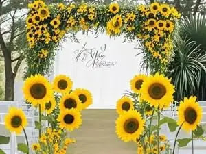 A floral archway decorated with yellow sunflowers framing a walkway.