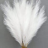 A close-up of white artificial reed stems used for home decor and events.
