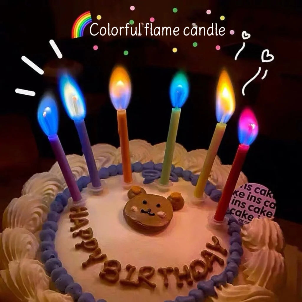 A colorful flame candle cake decorated with white frosting and blue borders.