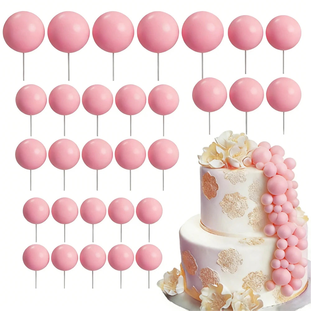 A set of pink foam cake toppers on sticks, including various round shapes and floral accents.