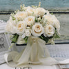 Elegant white silk rose bridal bouquet tied with a sheer ribbon
