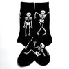 A pair of black novelty crew socks featuring skull, alien, and tiger prints.