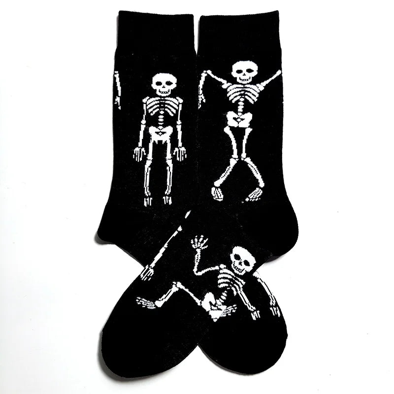A pair of black novelty crew socks featuring skull, alien, and tiger prints.