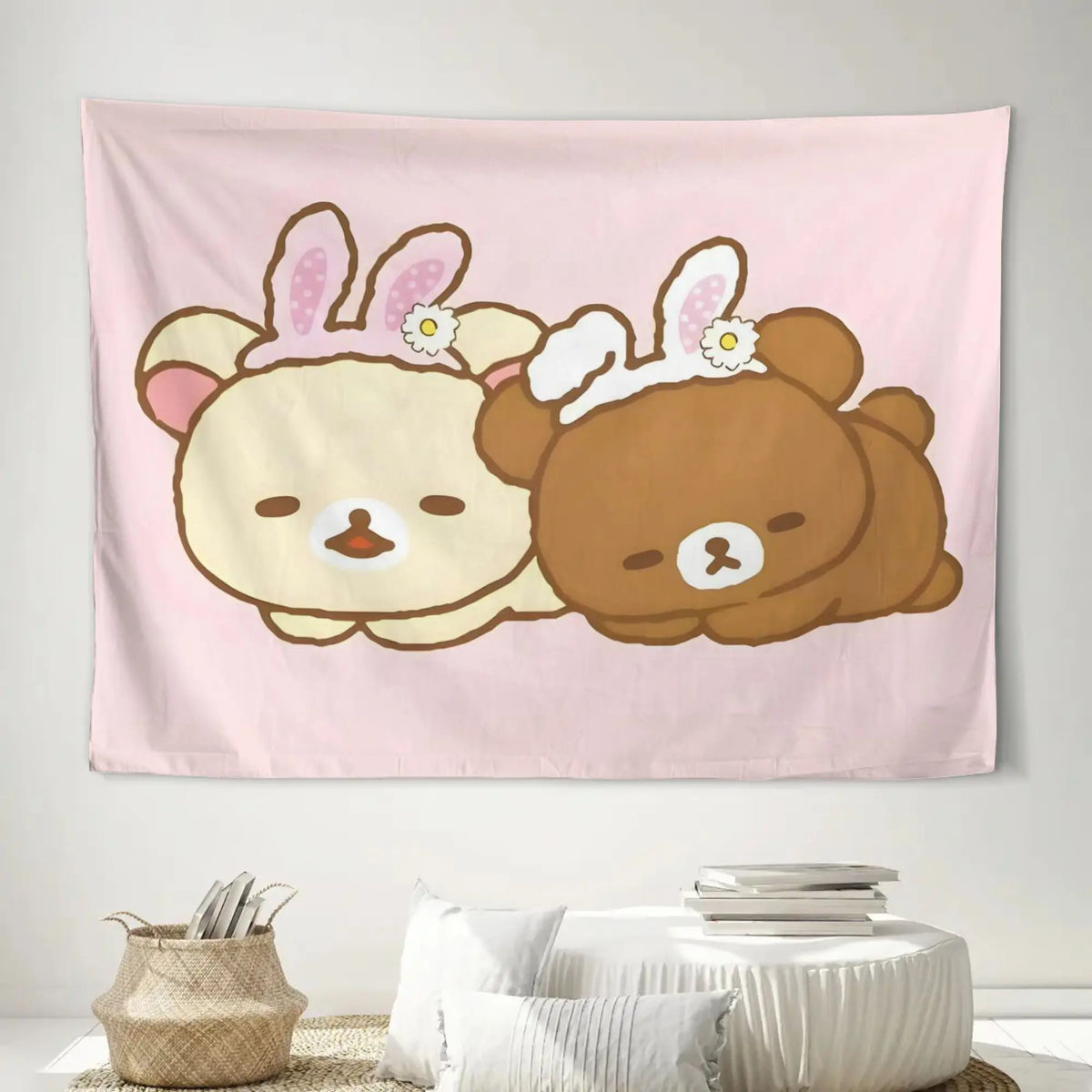 A pink tapestry featuring a cute cartoon bear illustration with pink ears and a smiling face.