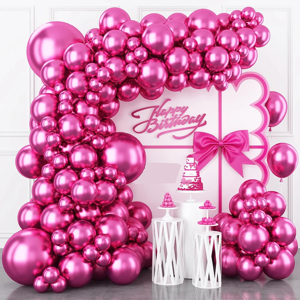 A large balloon arch decoration featuring pink and magenta balloons for a happy birthday party