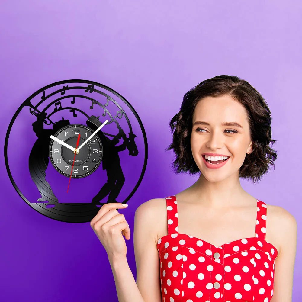A woman holds a black vintage vinyl record wall clock with a silhouette of a musician and a clock face against a purple backg