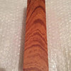 A vertical piece of reddish-brown wood with prominent, wavy grain patterns.