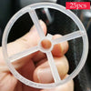 A hand holds a clear plastic balloon arch kit with a stand for weddings and parties.