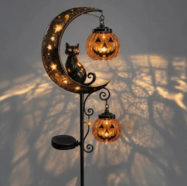 A solar Halloween lantern featuring a crescent moon silhouette with a black cat and hanging amber-colored lanterns.