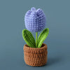 Handcrafted purple crochet tulip plant in a brown woven pot