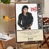 A poster featuring a black and white photo of Michael Jackson in a leather jacket with the title BAD