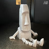 A white 3D printed Moai statue figurine with movable joints shown against a dark background.