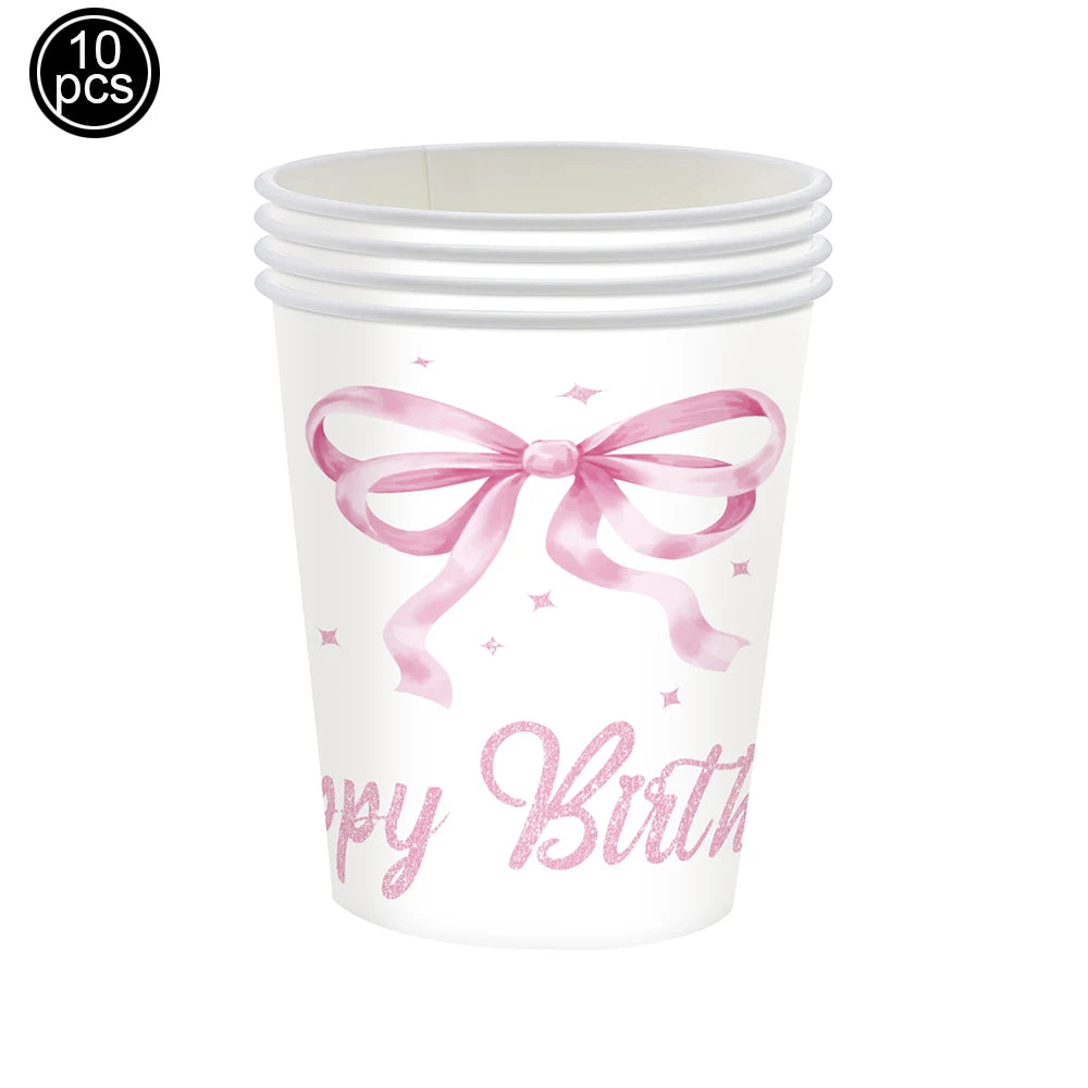 A white disposable cup with a pink bow design and the text 'Happy Birthday' printed on it.