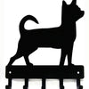 Black silhouette of a cat standing on decorative metal key hooks for wall organization