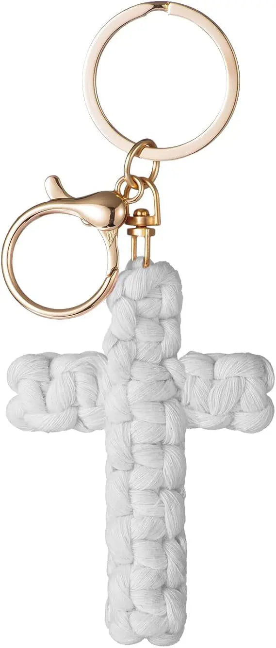 A bohemian woven white cross keychain with a gold-toned split ring and clasp.
