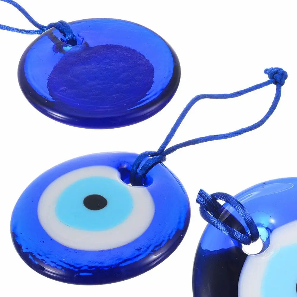 Blue glass evil eye amulet pendant with a white iris and black pupil on a blue background