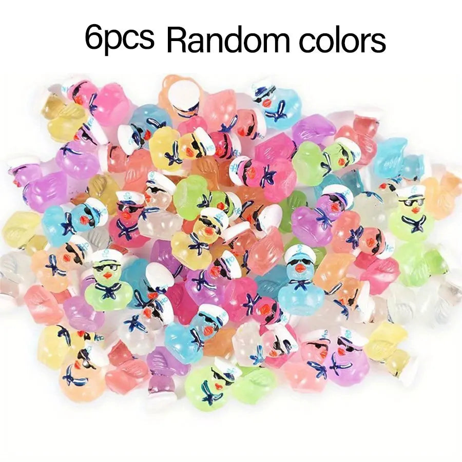 A pile of 6 pieces of glow-in-the-dark resin cruise duck decorations in random bright colors.