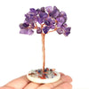 A natural crystal money tree decor featuring purple amethyst crystals mounted on a copper wire stem and a stone base.