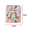 A pink and white photo book featuring two cartoon giraffes on a floral background.