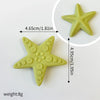 A light green star-shaped silicone cake topper with a pointed base, shown next to a measurement guide.