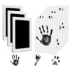 A set of white frames displaying black ink pet paw prints on a white background.