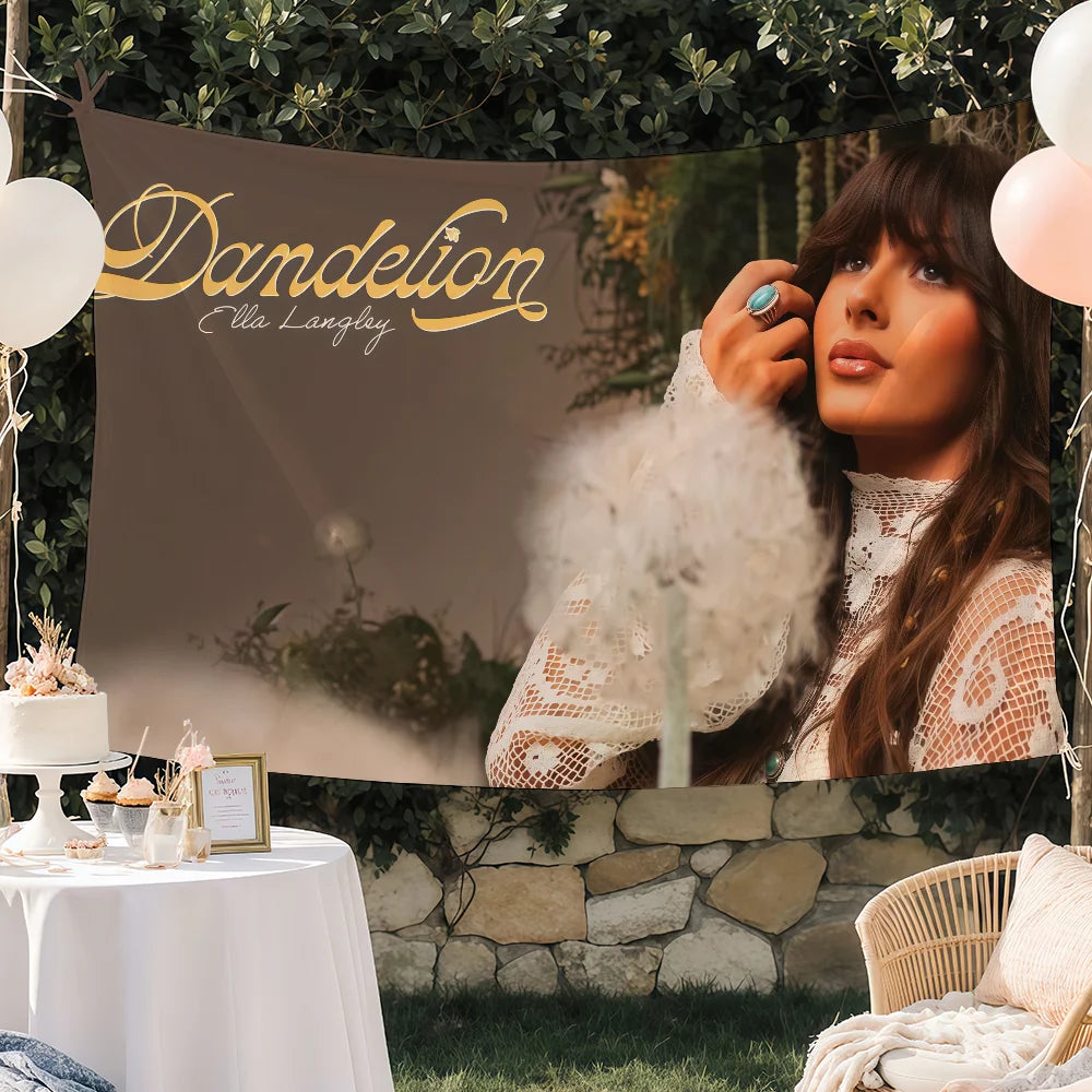 A woman with long brown hair is featured in a tapestry wall hanging with gold lettering that reads Dandelion Ella Langley