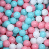 A pile of colorful, round plastic balls in pink, white, and light blue for play areas.