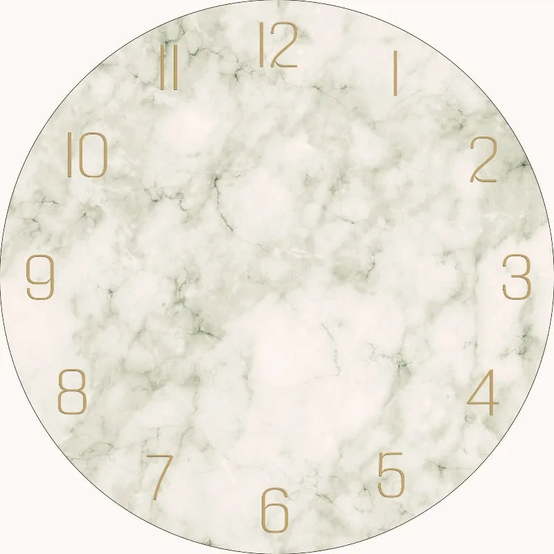 A round clock face with a marble texture and gold hour markers.