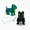 A vibrant green and blue 3D printed articulated bulldog figurine standing on a white block.