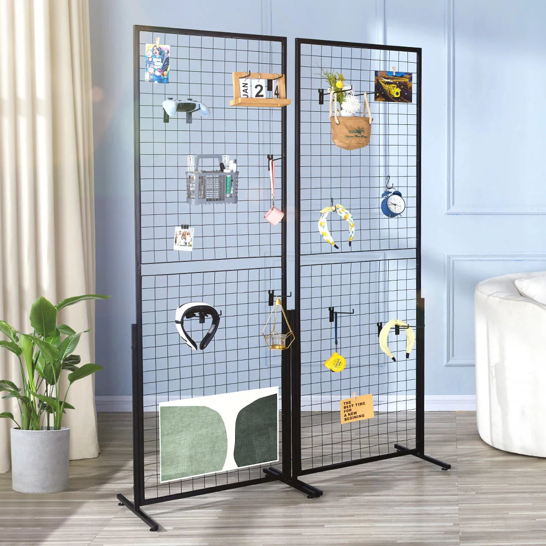 A black wire grid wall display rack featuring various small items and tools mounted on a transparent background.