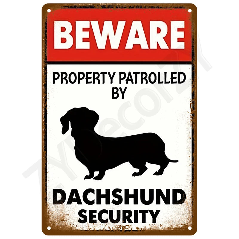 A vintage tin sign with a red and white warning that reads BEWARE PROPERTY PATROLLED BY DACHSHUND SECURITY