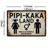 A vintage metal tin sign with the text Pipi-Kaka Land and restroom symbols for male and female restrooms.