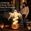 A glowing ghost rises from a pumpkin, illuminating an outdoor Halloween scene.