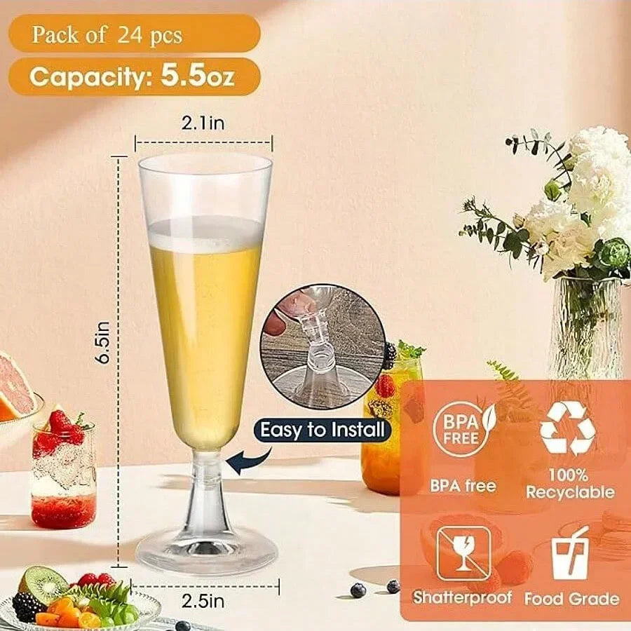 A set of disposable champagne glasses with a gold finish is shown next to an orange juice and flowers.