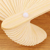 A light yellow bamboo folding fan with a white bead detail shown in a close-up view.