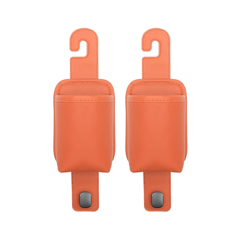 A pair of orange leather car seat back organizers with headrest hangers.
