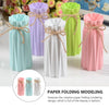A collection of modern origami plastic vases in pastel colors including mint green, lavender, white, and pink.