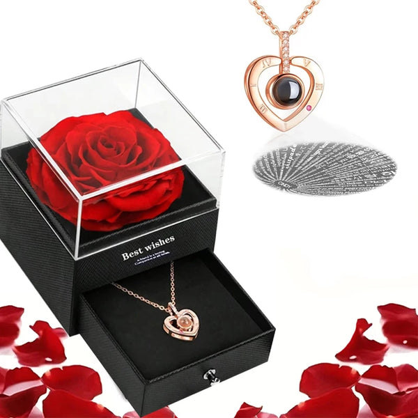 A gift set featuring a preserved red rose and a gold heart necklace displayed in a clear box.
