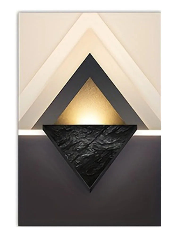 Modern geometric wall art featuring layered triangles in gold, black, and cream tones.