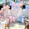 A display of pastel pink and blue balloons arranged in a balloon arch decoration for an event.