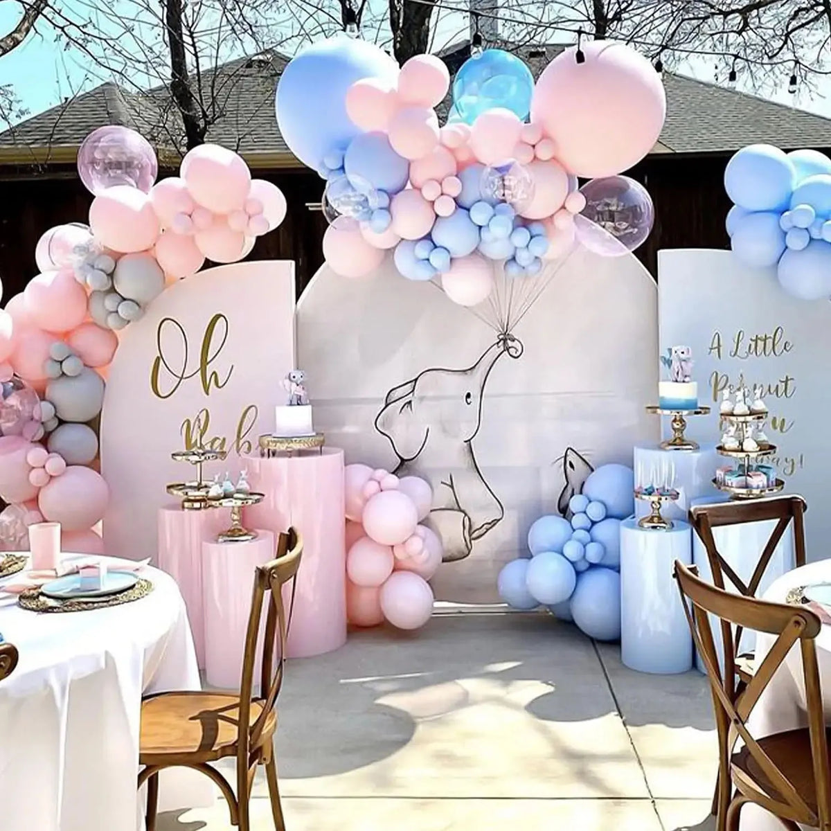 A display of pastel pink and blue balloons arranged in a balloon arch decoration for an event.
