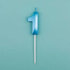A blue number one candle with a white stick against a light teal background.
