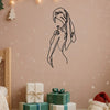 A black line art silhouette of a girl's profile on a wall, decorated with string lights and Christmas trees.